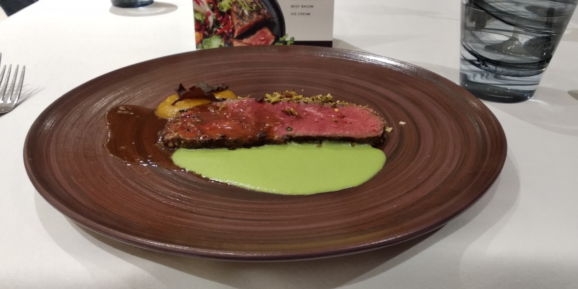 Dried cranberry, pistachio, brie and sage encrusted roast sirloin, pea & edamame puree, spiced pumpkin, black pepper gravy.